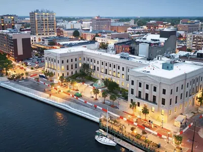 wilmington, nc historic buildings, boats, and streets bustling with lights.