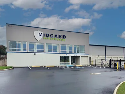 Modern Midgard Self Storage building with clear skies and empty parking lot