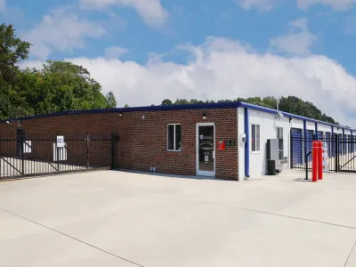 a brick building with a fence around it