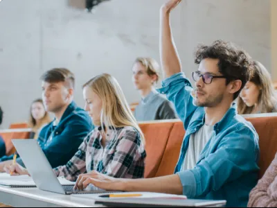 a group of people sitting in a classroom