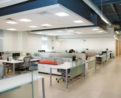 an empty office with tables and chairs