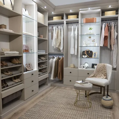 a closet with a chair and shelves