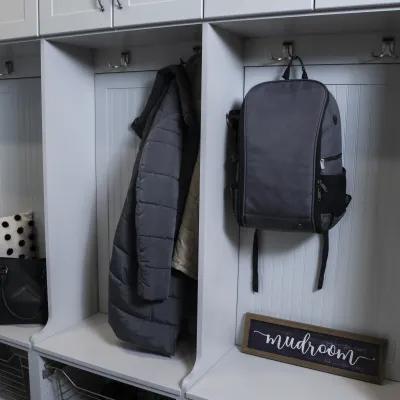 a mudroom with a variety of clothing and backpacks