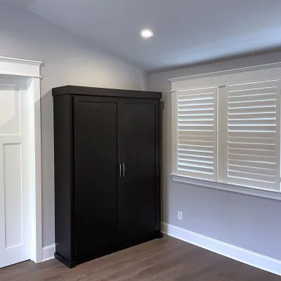 a room with a black door and white walls