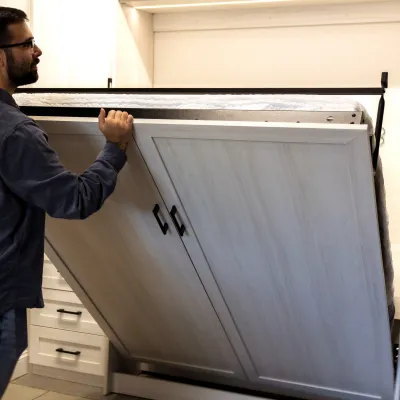 a man holding a large cabinet