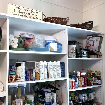 an organized pantry shelf with many items on it