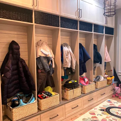 a closet with clothes and baskets