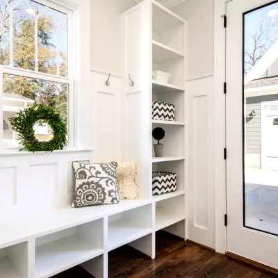 a white shelving unit with a window and a door