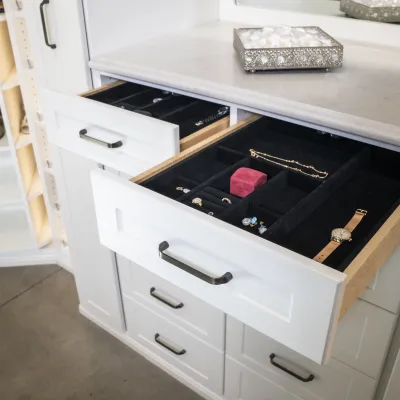 a white cabinet with shoes and shoes