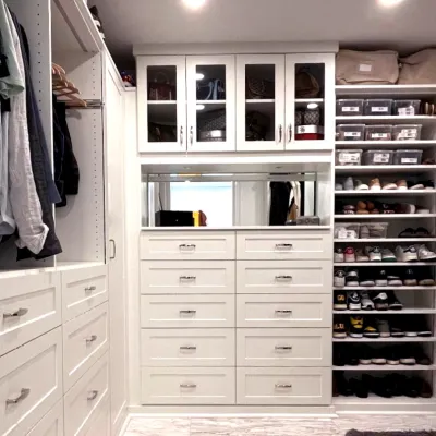 a closet with white cabinets