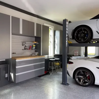 two white corvettes in a garage with custom storage solutions