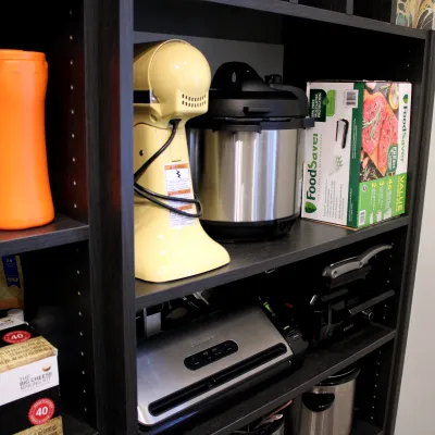 a coffee maker on a pantry shelf