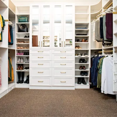a closet with white drawers