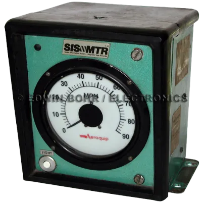 Aeroquip branded SIS MTR analog speedometer measuring up to 90 MPH in a green and black metal box.