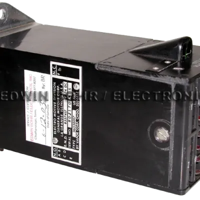 Black rectangular industrial electronic component with multiple wire connectors and identification labels attached.