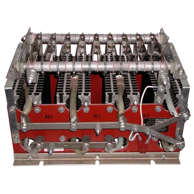 Industrial electrical transformer with metal coils, connectors, and wiring mounted on a red base.