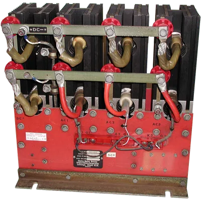 Industrial electrical component with coils, red and black wiring, mounted on a red metal base with labels.