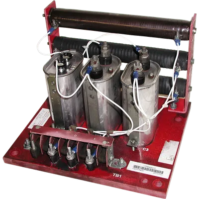 Three large capacitors connected with white wires mounted on a red base with coils and terminals for electrical testing.