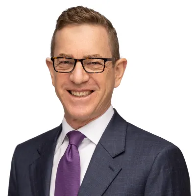 a man wearing glasses and a suit