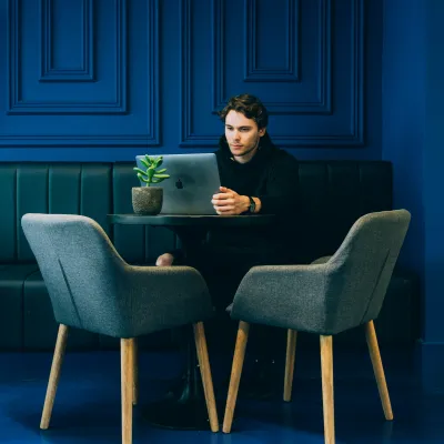 Tamás Lengyel sitting at a table with a laptop