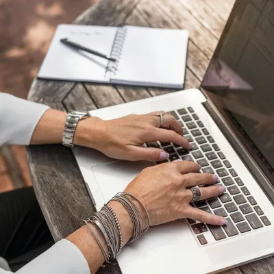 a person typing on a laptop