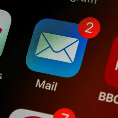 Blue mail app icon with two unread messages shown by red notification badge on smartphone screen.