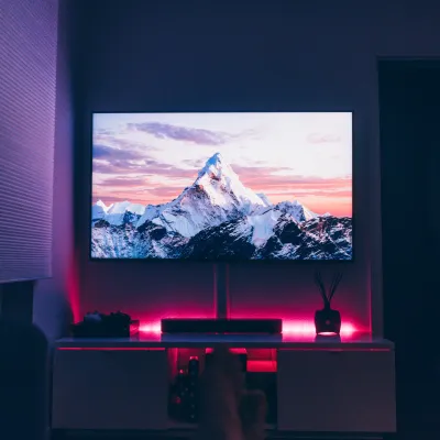 a person's feet in front of a television screen