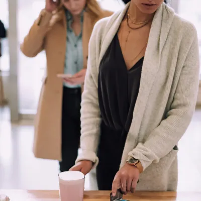 a few women looking at a cell phone