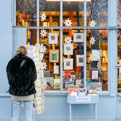 a person looking at a display of books