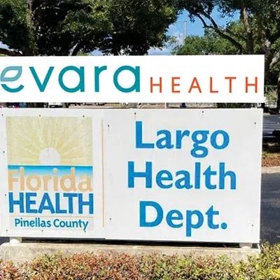 Sign for Largo Health Department and Florida Health Pinellas County with trees and parking lot in background