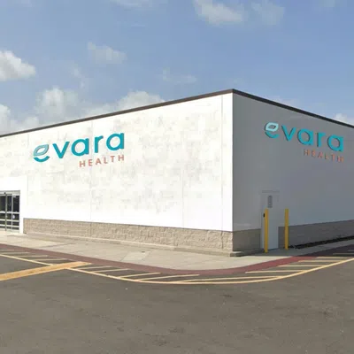 Exterior view of Evara Health building with American flag and clear blue sky on a sunny day