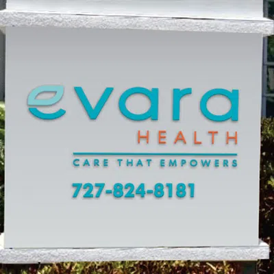 Evara Health sign displaying company name, tagline Care That Empowers, and phone number 727-824-8181 outdoors.