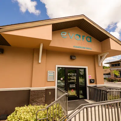 Exterior view of Evara Health Clearwater Dental building with entrance and wheelchair ramp on a sunny day.
