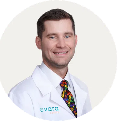 Portrait of a male doctor wearing a suit and stethoscope in a professional setting