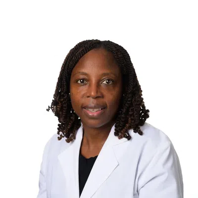 Professional woman with braided hair wearing a white lab coat over black top against white background