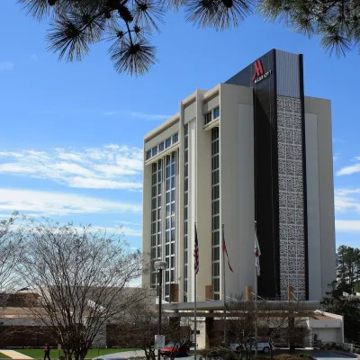 a tall building with trees in front of it