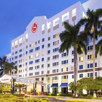 a building with palm trees in front