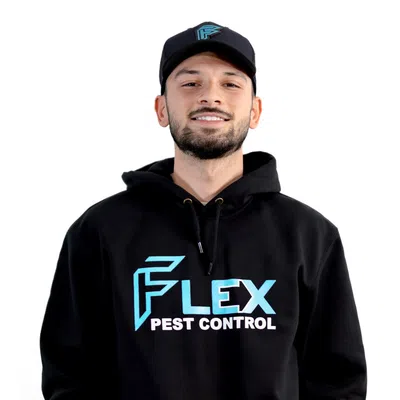 Man wearing black hoodie and cap with Flex Pest Control logo smiling against white background