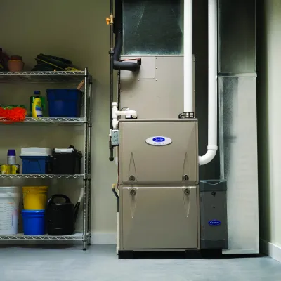 Modern home furnace and ventilation system in a tidy garage with storage shelves.