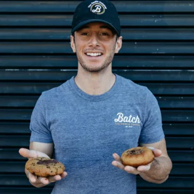 a person holding a couple of cookies