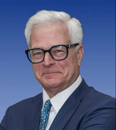 a man wearing glasses and a suit