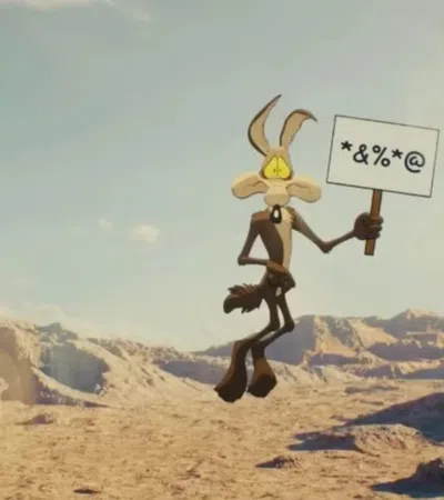 Cartoon coyote holds a sign with symbols in a desert canyon landscape under a clear sky.