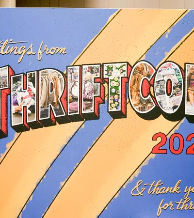 Colorful 'Greetings from ThriftCon 2026' sign with vibrant letters filled with thrift items on blue and yellow background.