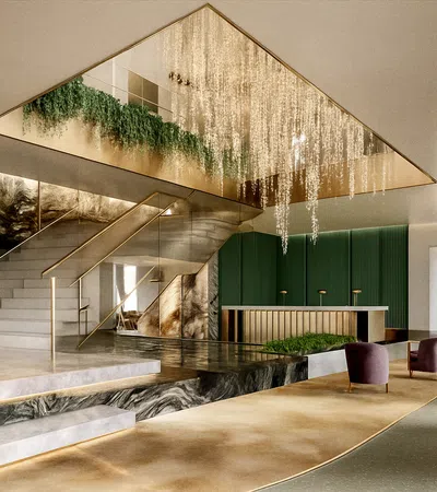 Luxurious lobby with marble staircase, gold chandelier, green walls, modern seating, and stylish reception desk