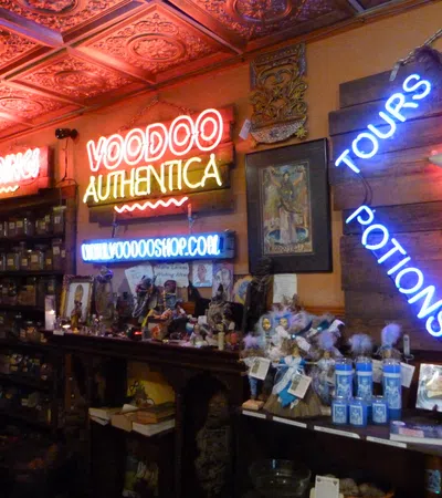 Interior of a voodoo shop with neon signs, shelves of jars, potions, dolls, and mystical items under ornate ceiling tiles.
