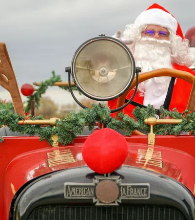 a red truck with a large christmas tree and a large silver ball