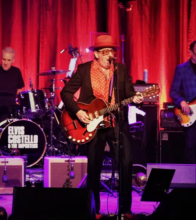 a group of men playing instruments on a stage