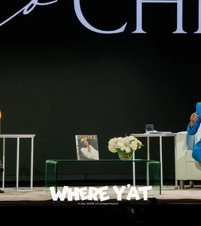 a couple of women sitting on a stage