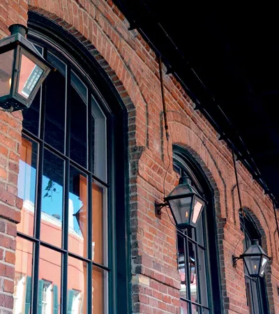 a brick building with a couple of street lamps on the side