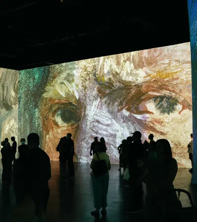 a group of people looking at a large piece of art
